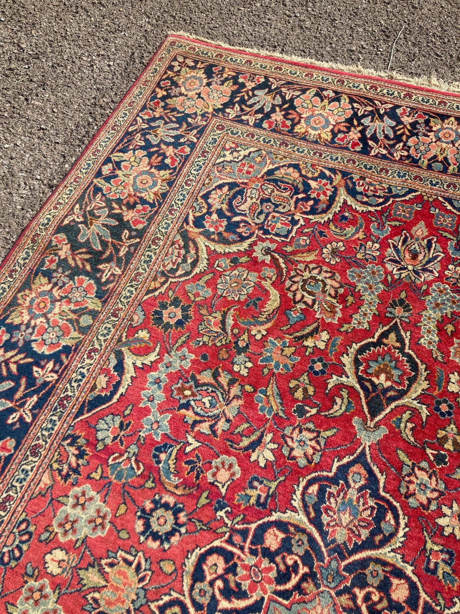 A Kashan red ground rug, with all-over stylised floral motifs